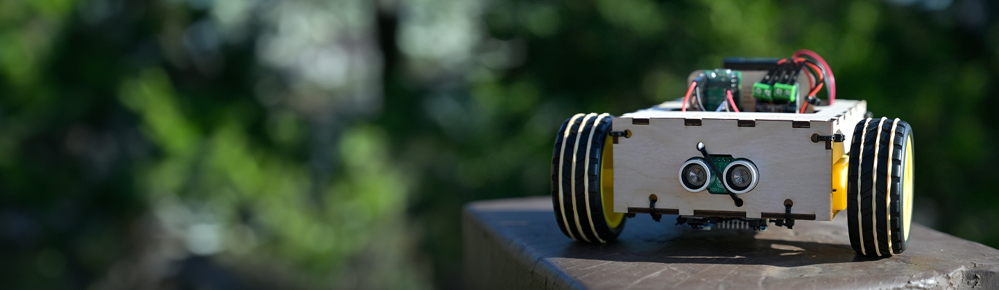 Outdoor photo of a Ro/Box outside, resting atop a square wooden pole